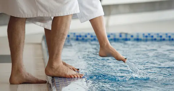 Someone testing the pool temperature with their toes.